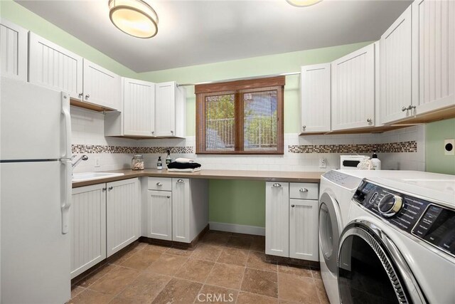 21925 Heatheridge Dr, Yorba Linda, CA 92887 - laundry room with washer and dryer, cabinet space, and stone finish flooring