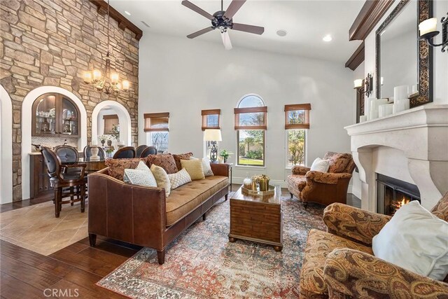 21925 Heatheridge Dr, Yorba Linda, CA 92887 - living area featuring a glass covered fireplace, a ceiling fan, a towering ceiling, arched walkways, and recessed lighting