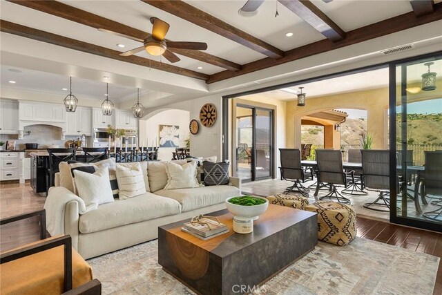 21925 Heatheridge Dr, Yorba Linda, CA 92887 - living area with a ceiling fan, arched walkways, wood-type flooring, plenty of natural light, and beam ceiling