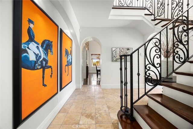21925 Heatheridge Dr, Yorba Linda, CA 92887 - entryway with arched walkways, stairway, and baseboards