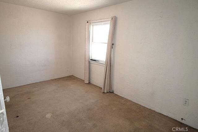120 W Williams St, Barstow, CA 92311 - unfurnished room featuring light colored carpet and a textured wall