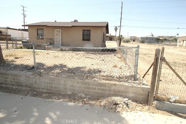 120 W Williams St, Barstow, CA 92311 - view of front of property featuring stucco siding and a fenced front yard