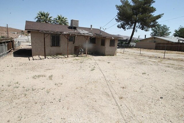 120 W Williams St, Barstow, CA 92311 - rear view of house featuring central AC and stucco siding