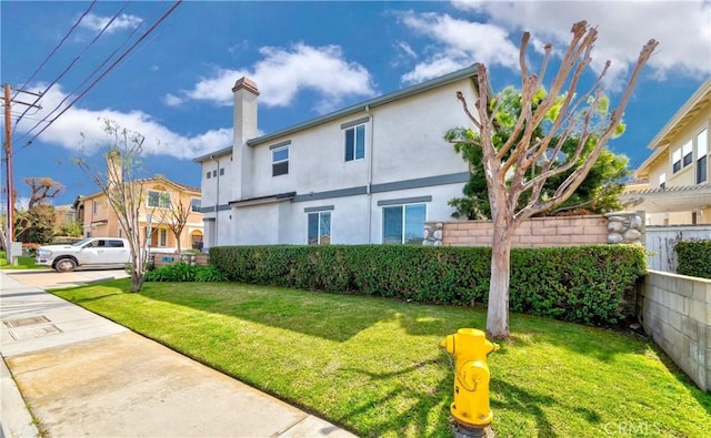 5612 Sprague Ave, Cypress, CA 90630 - rear view of house featuring stucco siding and a chimney