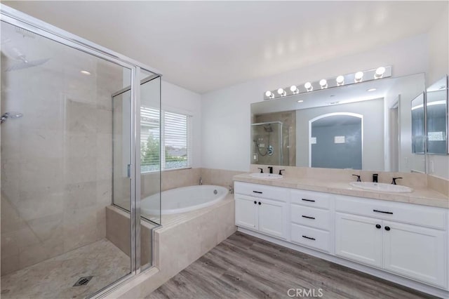 5612 Sprague Ave, Cypress, CA 90630 - full bathroom featuring a stall shower, a garden tub, double vanity, and wood finished floors