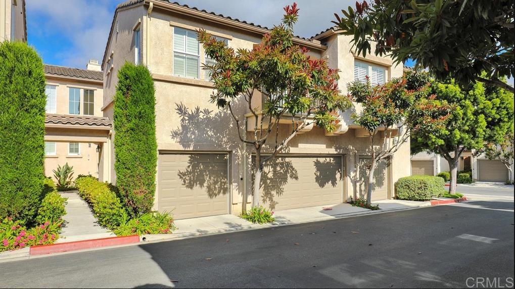 3767 Carmel View Rd Unit 4, San Diego, CA 92130 - view of front of house with stucco siding, a garage, and a tile roof