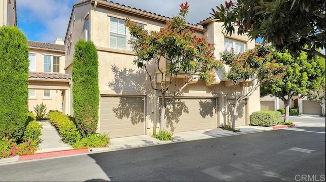 3767 Carmel View Rd Unit 4, San Diego, CA 92130 - view of front of house with stucco siding, a garage, and a tile roof