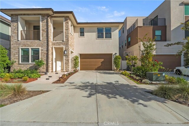 370 Sawbuck, Irvine, CA 92618 - modern home featuring stone siding, stucco siding, concrete driveway, and a garage