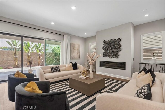 370 Sawbuck, Irvine, CA 92618 - living area featuring wood finished floors, recessed lighting, a glass covered fireplace, and baseboards