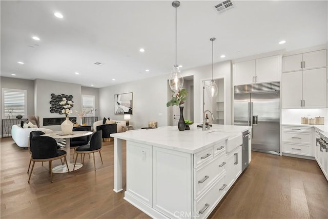 370 Sawbuck, Irvine, CA 92618 - kitchen featuring appliances with stainless steel finishes, a sink, open floor plan, light stone counters, and recessed lighting