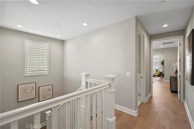 370 Sawbuck, Irvine, CA 92618 - corridor with an upstairs landing, light wood-style floors, recessed lighting, and baseboards