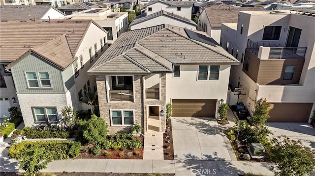 370 Sawbuck, Irvine, CA 92618 - view of front of house featuring a residential view, driveway, an attached garage, and stone siding