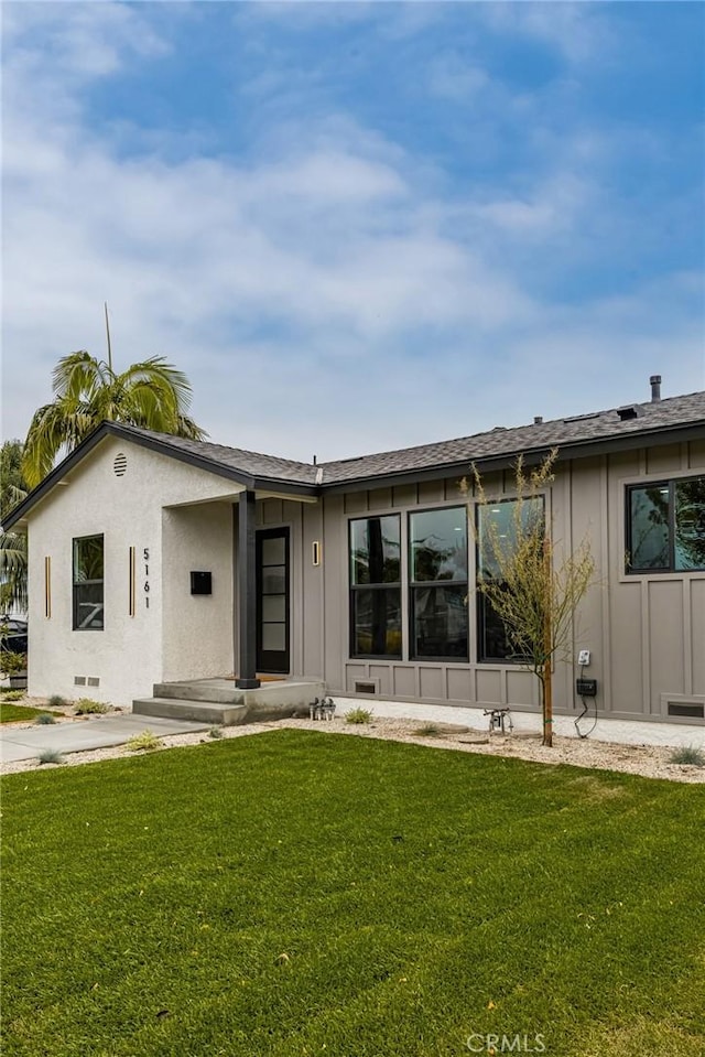 5161 E 27th St, Long Beach, CA 90815 - view of front of property with board and batten siding and a front lawn
