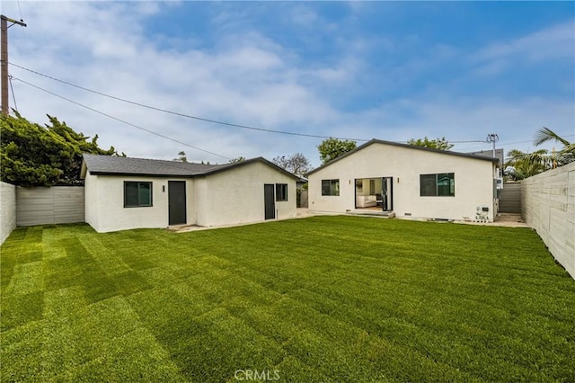 5161 E 27th St, Long Beach, CA 90815 - rear view of house with a fenced backyard and stucco siding
