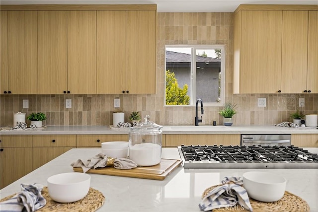 5161 E 27th St, Long Beach, CA 90815 - kitchen with light countertops, stainless steel appliances, light brown cabinets, and tasteful backsplash