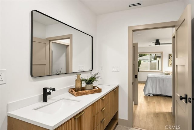 5161 E 27th St, Long Beach, CA 90815 - full bath with double vanity, wood finished floors, ceiling fan, and connected bathroom