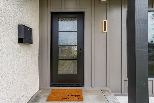 5161 E 27th St, Long Beach, CA 90815 - view of exterior entry featuring stucco siding and board and batten siding