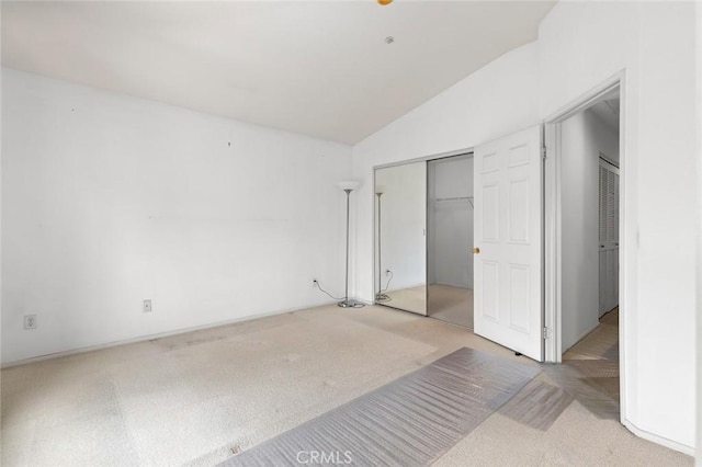69 Serena Way, Stanton, CA 90680 - unfurnished bedroom with light colored carpet, lofted ceiling, and a closet