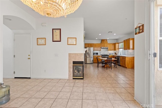 69 Serena Way, Stanton, CA 90680 - living area featuring light tile patterned flooring, a chandelier, arched walkways, and recessed lighting