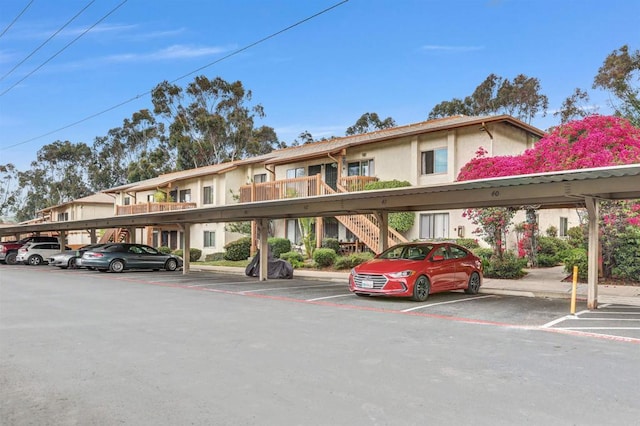 6362 Rancho Mission Rd Unit 712, San Diego, CA 92108 - view of property featuring covered parking and stairs