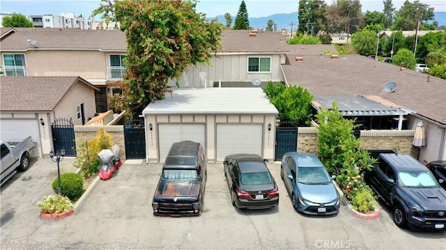 8601 Burnet Ave Unit D, North Hills, CA 91343 - townhome / multi-family property featuring a gate, a garage, board and batten siding, and a mountain view