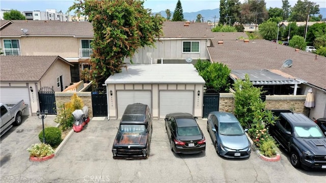 8601 Burnet Ave Unit D, North Hills, CA 91343 - view of front of home with board and batten siding, a gate, a mountain view, and driveway