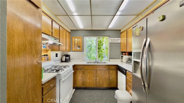 8601 Burnet Ave Unit D, North Hills, CA 91343 - kitchen with white appliances, under cabinet range hood, brown cabinetry, a sink, and light countertops