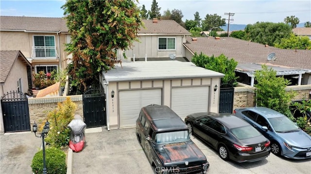 8601 Burnet Ave Unit D, North Hills, CA 91343 - view of front of house featuring a gate, a garage, driveway, and stucco siding