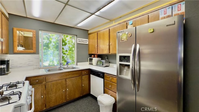 8601 Burnet Ave Unit D, North Hills, CA 91343 - kitchen with white appliances, a sink, brown cabinetry, light countertops, and tasteful backsplash