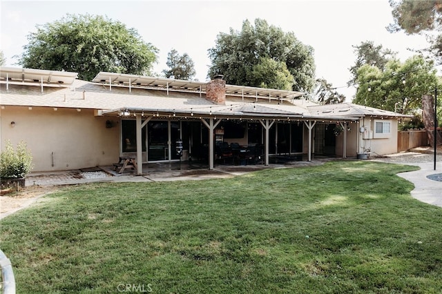 6384 E Lowe Ave, Fresno, CA 93727 - rear view of property featuring a patio area, stucco siding, and a chimney