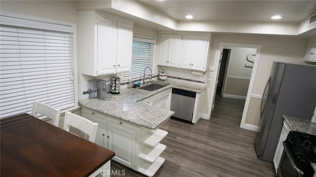6384 E Lowe Ave, Fresno, CA 93727 - kitchen featuring appliances with stainless steel finishes, a sink, white cabinets, a peninsula, and dark wood-style floors