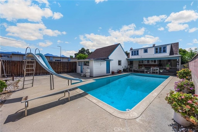 1995 Cadillac Dr, Pomona, CA 91767 - view of pool with a water slide, a patio, a fenced backyard, an outdoor structure, and a diving board