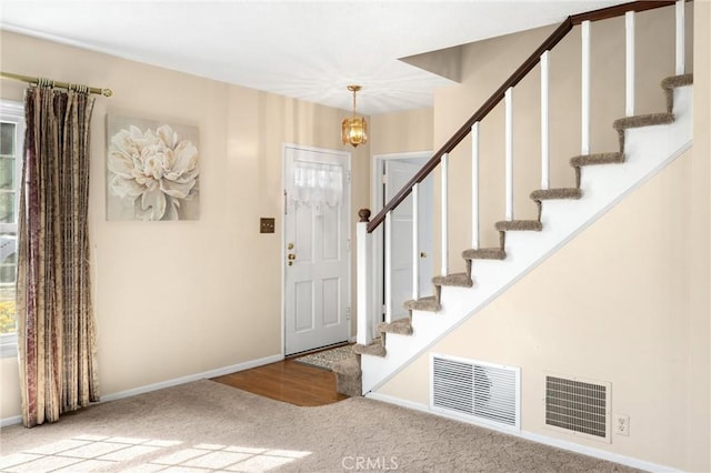 1995 Cadillac Dr, Pomona, CA 91767 - foyer entrance featuring stairs, carpet floors, and a chandelier