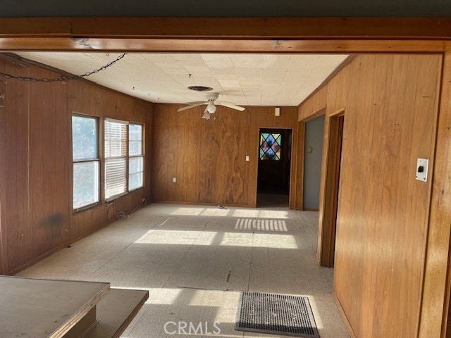100 Aliso St, Needles, CA 92363 - empty room with wood walls and ceiling fan