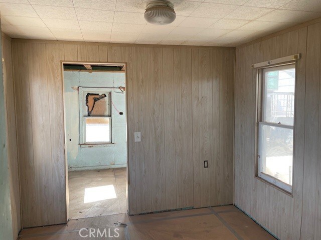 100 Aliso St, Needles, CA 92363 - unfurnished room with wooden walls
