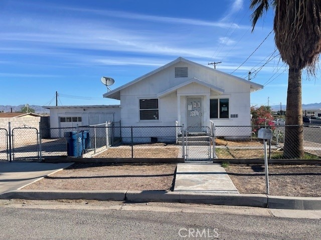 100 Aliso St, Needles, CA 92363 - bungalow-style house featuring a gate and a fenced front yard