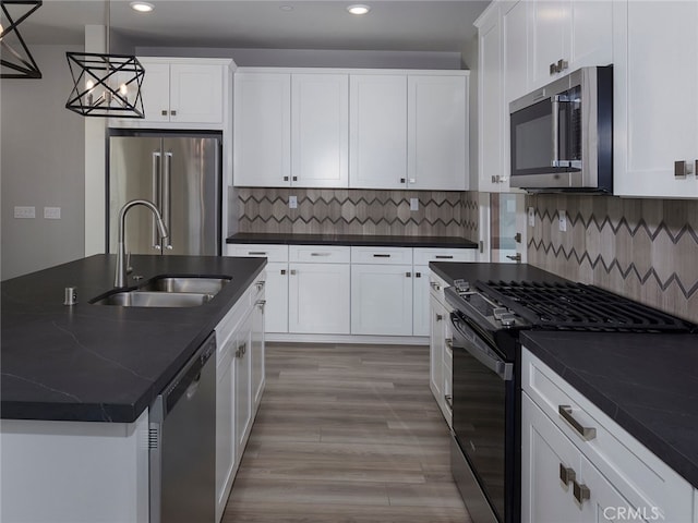 1474 Skyline Ln, San Pedro, CA 90732 - kitchen featuring appliances with stainless steel finishes, a sink, recessed lighting, dark countertops, and white cabinets