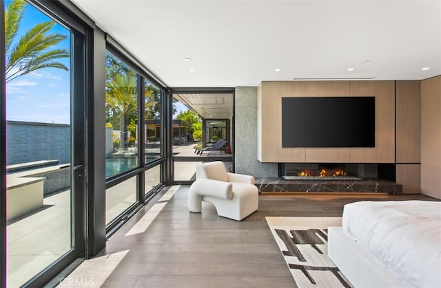 15 Torrey Pines Ln, Newport Beach, CA 92660 - bedroom with floor to ceiling windows, wood finished floors, a fireplace, and recessed lighting