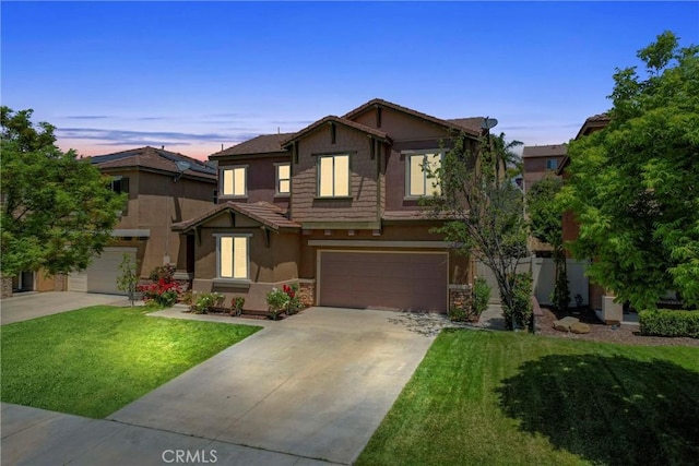 33184 Puffin St, Temecula, CA 92592 - view of front of property with stucco siding, a garage, driveway, a front yard, and stone siding
