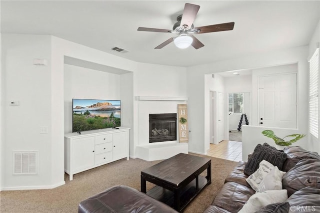 33184 Puffin St, Temecula, CA 92592 - living area with ceiling fan, a glass covered fireplace, carpet floors, baseboards, and healthy amount of natural light