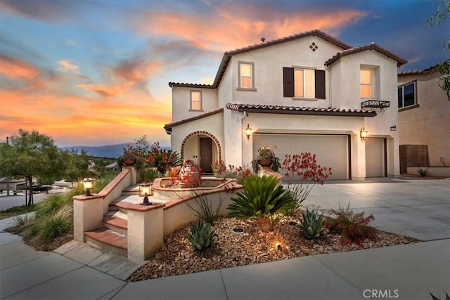 11313 Atlas Ct, Corona, CA 92883 - mediterranean / spanish-style home featuring a garage, stucco siding, a tile roof, and driveway