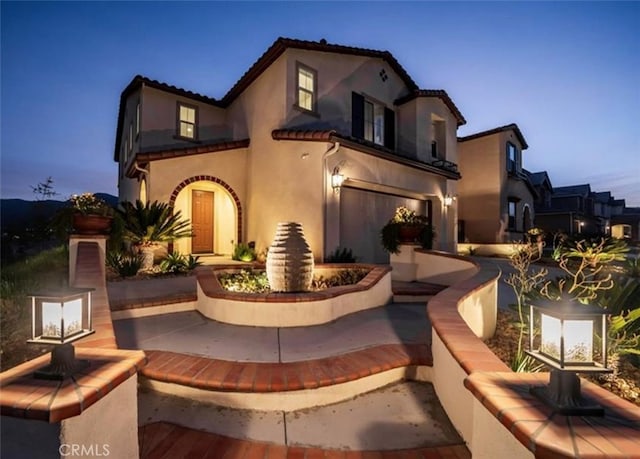 11313 Atlas Ct, Corona, CA 92883 - back of property featuring stucco siding, a garage, and a tiled roof