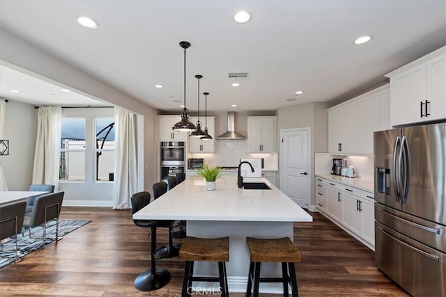 11313 Atlas Ct, Corona, CA 92883 - kitchen with stainless steel appliances, wall chimney exhaust hood, a breakfast bar, decorative backsplash, and white cabinets