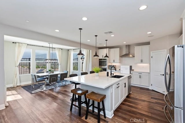 11313 Atlas Ct, Corona, CA 92883 - kitchen featuring appliances with stainless steel finishes, wall chimney range hood, white cabinets, light countertops, and recessed lighting