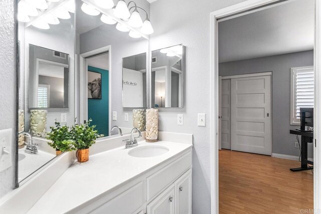 4610 Los Alamos Way Unit C, Oceanside, CA 92057 - bathroom with vanity, wood finished floors, and baseboards