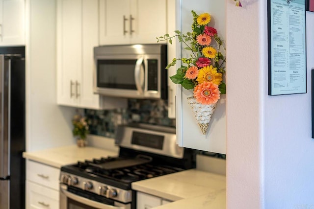 4610 Los Alamos Way Unit C, Oceanside, CA 92057 - kitchen with appliances with stainless steel finishes, light countertops, and white cabinetry