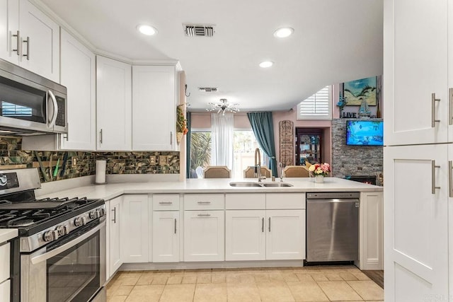 4610 Los Alamos Way Unit C, Oceanside, CA 92057 - kitchen featuring appliances with stainless steel finishes, a sink, light countertops, tasteful backsplash, and white cabinetry