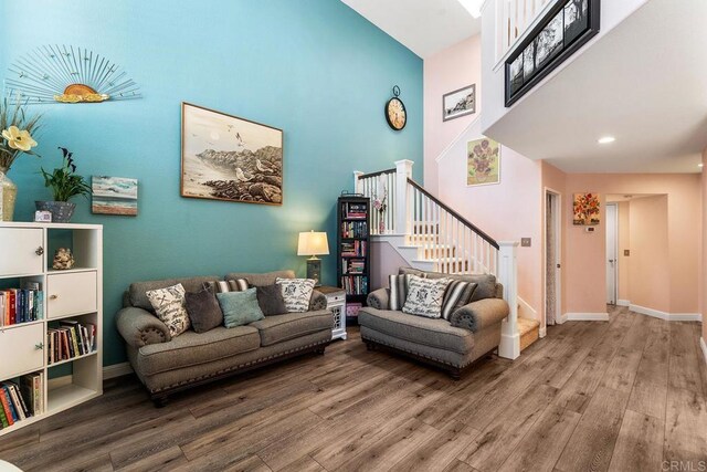 4610 Los Alamos Way Unit C, Oceanside, CA 92057 - living room featuring a towering ceiling, wood finished floors, stairway, and baseboards