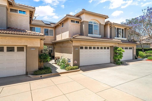4610 Los Alamos Way Unit C, Oceanside, CA 92057 - view of front of property featuring an attached garage, a tiled roof, stucco siding, and concrete driveway