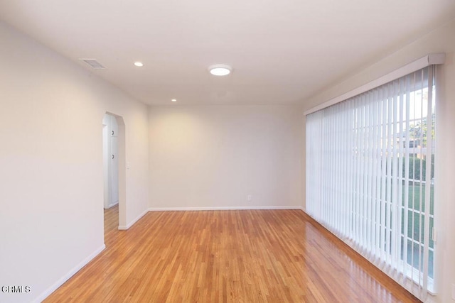 139 Spanner St, Monrovia, CA 91016 - empty room with light wood finished floors, baseboards, arched walkways, and recessed lighting